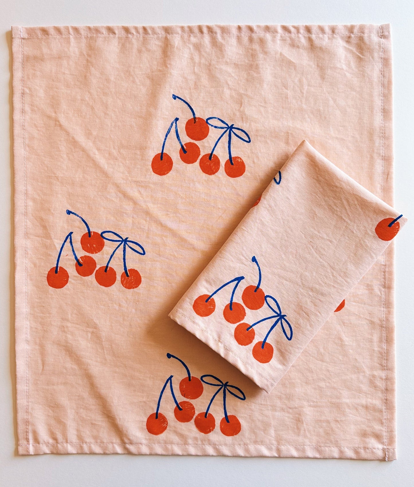Orange Cherry on Blush Dinner Napkins